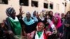 FILE - Sudanese pro-democracy supporters celebrate a final power-sharing agreement with the ruling military council, in Khartoum, Aug. 17, 2019. For the first time in three decades, Sudan has charted a path out of military rule.