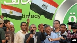 The Muslim Brotherhood's General Guide Mohammed Badie speaks onstage as military helicopters fly overhead before tens of thousands of supporters in Cairo, Egypt, July 5, 2013.