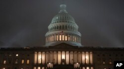 The U.S. Capitol in Washington is shrouded in mist, Friday night, Dec. 13, 2019, at the end of an acrimonious week of partisan disputes in the House Judiciary Committee which approved two articles of impeachment against President Donald Trump,…