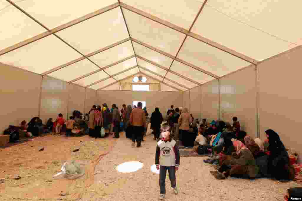 Refugees register their names after their arrival at the Al Zaatri refugee camp near the border with Syria, March 6, 2013. 