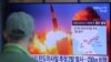 FILE - A man watches a TV screen showing a file image of North Korea's missile launch during a news program at the Seoul Railway Station in Seoul, South Korea, March 29, 2020.